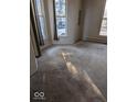 Empty living room with neutral carpet and a window offering natural light and view of the neighborhood at 9278 S Geneva Rd, Flat Rock, IN 47234