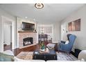 Elegant living room with a fireplace, hardwood floors, and open access to the dining area at 9531 Prospect St, Indianapolis, IN 46239