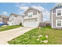Well-maintained two-story home with a two-car garage, green lawn, and classic siding at 1012 Balto Dr, Shelbyville, IN 46176