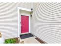Close-up of the red front door, enhancing curb appeal with its inviting color and clean design at 1012 Balto Dr, Shelbyville, IN 46176