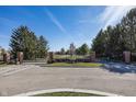 Gated community entrance featuring manicured landscaping, mature trees, and a secure entry system at 10415 Charter Oaks, Carmel, IN 46032