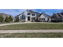 Beautiful two-story home with a large front lawn, circular driveway, and meticulous landscaping at 10415 Charter Oaks, Carmel, IN 46032