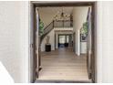 Elegant foyer with a grand staircase, chandelier, hardwood floors, and an open layout at 10415 Charter Oaks, Carmel, IN 46032