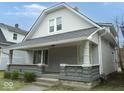 Quaint two-story home with a cozy front porch and classic design elements at 1056 N Mount St, Indianapolis, IN 46222