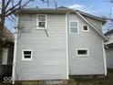 Side view of a two-story home featuring durable siding and well-placed windows for natural light at 1056 N Mount St, Indianapolis, IN 46222