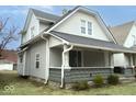 Charming two-story home featuring a welcoming front porch and traditional architectural details at 1056 N Mount St, Indianapolis, IN 46222