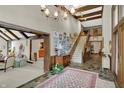 Grand foyer features staircase, high ceilings, beautiful decor, and seamless access to other living spaces at 10614 Winterwood, Carmel, IN 46032
