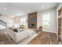 Bright living room featuring a modern fireplace, sleek hardwood floors, and contemporary decor for a stylish and comfortable space at 10628 Mangrove Dr, Indianapolis, IN 46239