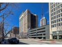 An eye-level street view showcasing the building's architecture and urban setting on a sunny day at 110 E Washington St # 802, Indianapolis, IN 46204