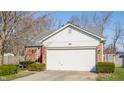 Charming single-Gathering home featuring brick accents, a white garage door, and well-maintained landscaping at 11930 Titania Cir, Indianapolis, IN 46236