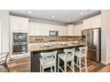 Modern kitchen with granite countertops, stainless steel appliances, and island seating at 13082 Overview Dr # 5A, Fishers, IN 46037