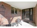 Cozy brick front porch featuring iron seating and a view of the home's entry at 153 Monticello Ct, Noblesville, IN 46060