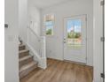 Welcoming entryway featuring a carpeted staircase and view of the outdoors at 15982 Meadow Frost Ct, Fishers, IN 46037