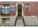 A charming brick apartment building features a private entrance with a small staircase and an arched entryway at 226 N Cleveland St # 226E, Indianapolis, IN 46204