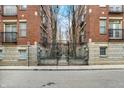 Apartment building with iron gates and a landscaped courtyard; perfect for urban living at 226 N Cleveland St # 226E, Indianapolis, IN 46204