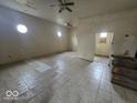 Blank canvas of an open living room with neutral tile flooring, ready for a new vision at 2420 N Macedonia Ave, Muncie, IN 47303