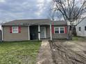 Exterior view of a single-story home featuring red shutters and a basketball hoop at 2813 Baltimore Ave, Indianapolis, IN 46218