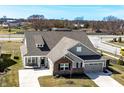 Aerial view of a well-maintained single-Gathering home, showcasing its brick and siding exterior and manicured lawn at 3252 Jasper Ln, Brownsburg, IN 46112