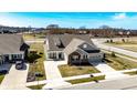 An aerial view of a well-kept home with pristine lawn, driveway, and nearby greenery at 3252 Jasper Ln, Brownsburg, IN 46112