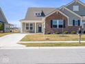 A charming home with a well-manicured lawn and an inviting front porch, set in a quiet neighborhood at 3252 Jasper Ln, Brownsburg, IN 46112