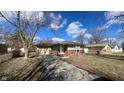 Charming single-story home featuring a brick facade, attached garage, and well-maintained front yard at 3830 Aloda St, Indianapolis, IN 46203