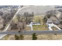 An aerial view showcasing a home with a long driveway, separate garage, and expansive front lawn at 4251 W 176Th St, Sheridan, IN 46069