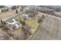 An aerial perspective showing two houses, large yards, and a nearby agricultural field, highlighting the spacious setting at 4251 W 176Th St, Sheridan, IN 46069