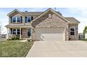 Attractive two-story home featuring brick accents and a well-maintained lawn at 5806 Belvista Dr, Plainfield, IN 46168