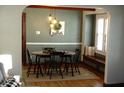 Dining area with hardwood floors, modern light fixtures, and decorative accents at 6041 Dewey Ave, Indianapolis, IN 46219