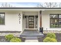 Front porch features a unique glass block window, providing a modern look and natural light at 671 Spring Hills Dr, Zionsville, IN 46077