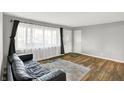 Inviting living room with new floors, a large window, fresh paint and a comfortable couch at 7133 Mc Lain Dr, Indianapolis, IN 46217