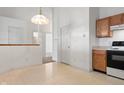 Open concept area featuring views of an adjacent kitchen with tiled floors, white walls, and light wood cabinets at 7164 Long Shore Cir, Indianapolis, IN 46217