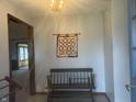 Inviting entryway with tiled floors, bench seating, and chandelier lighting at 805 Stewart Rd, Anderson, IN 46012
