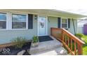 Inviting front porch with a decorative flower pot, dark shutters, and updated door at 868 Glendale Dr, Franklin, IN 46131