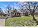Lovely home with a brick exterior, an attached garage, and a well-maintained green lawn at 884 W 146Th W St, Carmel, IN 46032