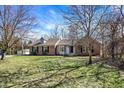 Beautiful single-story home with a brick facade and a lush, green lawn on a sunny day at 884 W 146Th W St, Carmel, IN 46032
