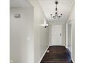 Inviting hallway featuring hardwood floors, a white paneled ceiling, and stylish light fixtures at 884 W 146Th W St, Carmel, IN 46032