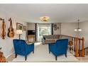 Bright living room featuring two velvet armchairs, a cozy sofa, and a large window at 9462 Bent Brook Dr, Indianapolis, IN 46250