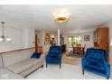 Open-concept living space with modern lighting, comfortable seating, and a dining area at 9462 Bent Brook Dr, Indianapolis, IN 46250