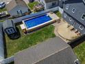 Private backyard with in-ground pool, patio area, and fenced yard at 97 N Maple St, Pittsboro, IN 46167