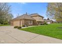 Two-story home with brick and siding, attached garage and driveway at 10673 Rolling Springs Dr, Indianapolis, IN 46234