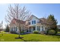 Beautifully landscaped two-story home with well-maintained lawn and welcoming facade at 13875 Ambria Dr, McCordsville, IN 46055