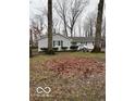 Cozy single-story house with a well-kept lawn and mature trees around the house at 1536 W 74Th Pl, Indianapolis, IN 46260