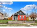 This home boasts great curb appeal, featuring a colorful two-tone exterior and a well-kept front yard at 1715 E Kelly St, Indianapolis, IN 46203