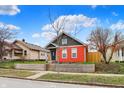 Attractive exterior of home boasts a colorful two-tone exterior and a well-kept front yard at 1715 E Kelly St, Indianapolis, IN 46203