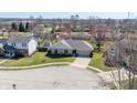 Aerial view of a well-maintained ranch-style home with a manicured lawn in a quiet residential neighborhood at 2231 Reston Ln, Columbus, IN 47203