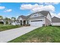 Beautiful single-story home with a large driveway and attached two-car garage at 2795 Lanai Ln, Greenwood, IN 46143