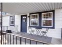 Charming covered porch area with seating, perfect for enjoying the outdoors and relaxing at home at 300 Indiana Ave, Pendleton, IN 46064