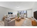 Bright living room with hardwood floors, stylish furniture, and plenty of natural light from large windows at 3109 Welch Dr, Indianapolis, IN 46224