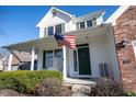 Inviting front porch with white columns, green door, and American flag displayed at 3468 Glen Abbe Ct, Carmel, IN 46032